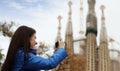 Female tourist photographing Sagrada Familia at Barcelona