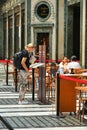 Female tourist read menu at restaurant terrace Turin Italy