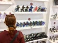 A female tourist shopping for glass sculptures at a shop in Murano, Italy. Murano is famous for its Venetian glass