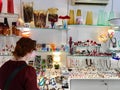 A female tourist shopping for glass sculptures at a shop in Murano, Italy. Murano is famous for its Venetian glass