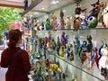 A female tourist shopping for glass sculptures at a shop in Murano, Italy. Murano is famous for its Venetian glass