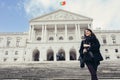 Female tourist standing in front of the Parliament of Portugal, Assembly of the Republic