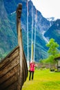 Tourist with camera near old viking boat, Norway Royalty Free Stock Photo