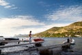 Female tourist standing on wooden pier and looking at fantastic croatian coast view. Travel Dubrovnik, Croatia Royalty Free Stock Photo