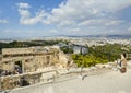 A female tourist takes a photo of Athens, Greece from Acropolis Hill