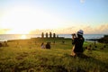 Female Tourist Taking Photos of the Famous Sunset Scene at Ahu Tahai, Archaeological site on Easter Island, Chile