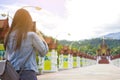 Female tourist taking picture of Buddhist temple in with mobile smart phone