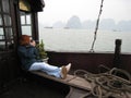 Female tourist taking pictures from a boat in Ha Long Bay in Vietnam Royalty Free Stock Photo