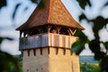 Female tourist taking pictures of the sunset, up in medieval tower, in the fortified Evangelical church of Alma Vii, Transylvania.