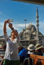 Female tourist taking selfie photo on a cruise boat in Istanbul