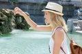 Female tourist throwing coin in water at trevi fountain