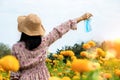 Female tourist travel in a beautiful flower garden taking off protective mask and breathe deep fresh air
