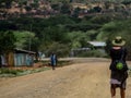 Female tourist walking on the dirt road at the Turmi, Omo Valley, Ethiopia