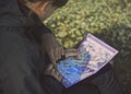 Female tourist watching a map of Landmannalaugar valley