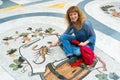 Female tourist on the Zodiac sign Scorpio in Galleria Umberto I