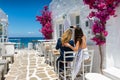 Female tourists are taking a selfie photo in the whitewashed alleys of Naousa village on Paros Royalty Free Stock Photo