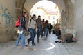 Female tourists and tramp near center of Slovakia monument near Michael`s Gate on Michalska street