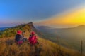 2 female tourists watching the sunset in the mountains