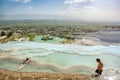 Female tourists wear bathing suits and soak in natural mineral springs at Pamukkale during the