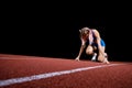 Female track runner on the starting block