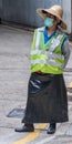 Female traffic warden at parking exit, Kowloon, Hong Kong China