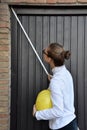 Female trainee measures a wall