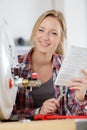 Female trainee plumber checking boiler instructions