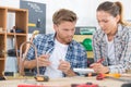 female trainee plumber working on central heating boiler Royalty Free Stock Photo