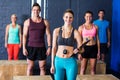 Female trainer with athletes by in fitness studio Royalty Free Stock Photo