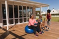 Female trainer training senior couple in performing exercise with dumbbells and exercise ball in the Royalty Free Stock Photo