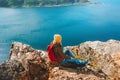 Female traveler with backpack enjoying aerial fjord view travel hiking outdoor in Norway active healthy lifestyle