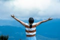 Female traveler enjoying the beauty of nature on the mountain looking at the lush trees in the tropical forest. Hipster woman Royalty Free Stock Photo