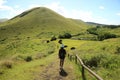 Female Traveler Exploring Puna Pau Crater, the Red Scoria Quarry for Moai Statues` Topknots Called Pukao, Easter Island of Chile