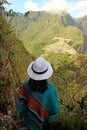 Female traveler impressed by the amazing aerial view of the Inca citadel ruins of Machu Picchu view from Huayna Picchu mountain, Royalty Free Stock Photo
