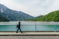 Female traveler and kurobe dam at tateyama kurobe alpine route