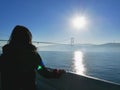 Female traveler looking out at view of Bosphorus bridge, Turkey