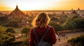 Female traveler photographing temples at Bagan Myanmar Asia at sunrise