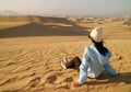 Female traveler resting on the sand dune of Huacachina desert in Ica Region, Peru, South America Royalty Free Stock Photo