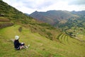 Female Traveler Sitting on the Ancient Inca Agricultural Terraces at Pisac Archaeological site, Sacred Valley, Cusco region, Peru