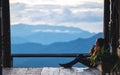 A female sitting and looking at a beautiful mountain and nature view before sunset Royalty Free Stock Photo