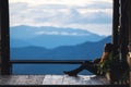 A female sitting and looking at a beautiful mountain and nature view before sunset Royalty Free Stock Photo