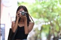 Traveler taking photo outdoors with digital camera. Royalty Free Stock Photo