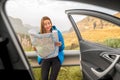 Female traveler with toursit map near the car Royalty Free Stock Photo