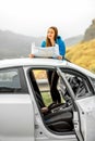 Female traveler with toursit map near the car Royalty Free Stock Photo