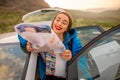 Female traveler with toursit map near the car Royalty Free Stock Photo