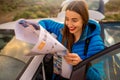 Female traveler with toursit map near the car Royalty Free Stock Photo