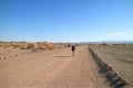 Female Traveler Walking on the Desert Road of Aldea de Tulor Archaeological Site, Atacama Desert, Northern Chile Royalty Free Stock Photo