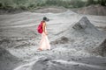 Female traveler walking near mud volcanoes Royalty Free Stock Photo