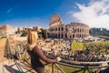 Female traveler watching over the Colosseum in Rome, Italy