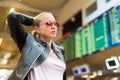 Female traveller checking flight departures board. Royalty Free Stock Photo